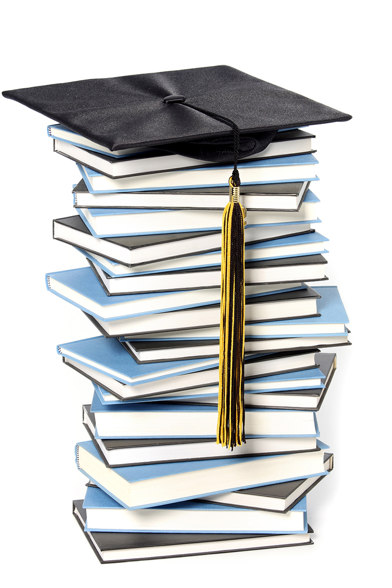 School books and graduation cap